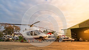 Helicopter in the parking lot or runway waiting for maintenance with sunrise background,twilight helicopter on the helipad