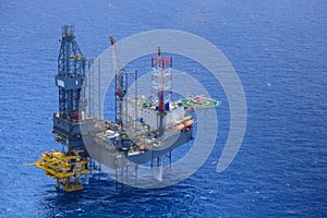 Helicopter pick up passenger on the offshore oil rig.