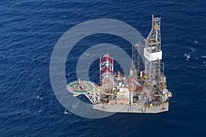 Helicopter pick up passenger on the offshore oil rig.