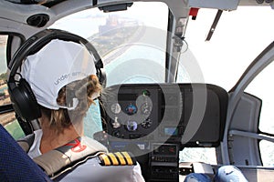Woman Helicopter pilot flying over the hotel Atlantis The Palm Dubai, UAE