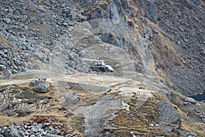 Helicopter taking off between the mountains of Nepal`s Langtang National Park
