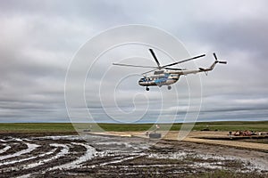 The helicopter took off from the wooden heliport in the tundra.