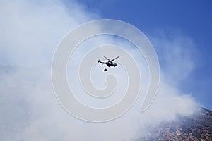 Helicopter trying to extinguish a mountain fire