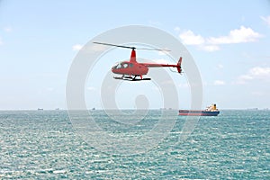 A helicopter used to receive a pilot on a sea vessel. Gladstone QLD, Australia.