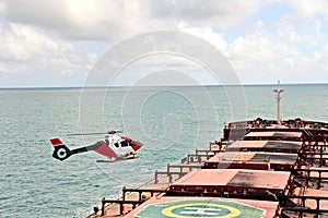 A helicopter used to receive a pilot on a sea vessel. Gladstone QLD, Australia.