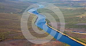 Helicopter view of the autumn Siberian taiga and the Tunguska River with its tributary