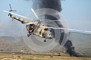 Helicopters mounting a ground attack with explosions and smoke