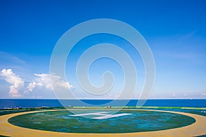 Helideck on oil rig with blue sky