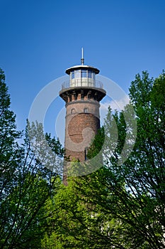 helios lighthouse behind trees