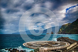 Helipad located in Porto Moniz, North of Madeira Island. In the background there are blue ocean waves