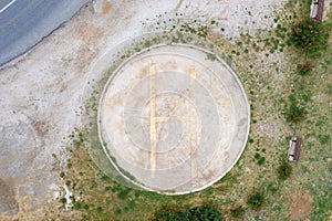 Helipad sign, yellow color letter H on the ground. Helicopters landing area