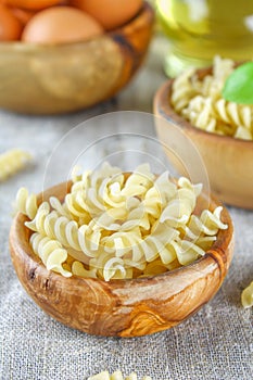 Helix- or corkscrew-shaped pasta. Rotini macaroni. Related to fusilli, but has a tighter helix, i.e. with a smaller pitch.