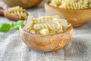 Helix- or corkscrew-shaped pasta. Rotini macaroni. Related to fusilli, but has a tighter helix, i.e. with a smaller pitch.