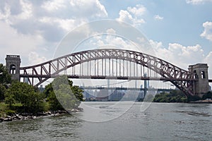 The Hell Gate Bridge along the Astoria Queens New York Riverfront over the East River during Summer