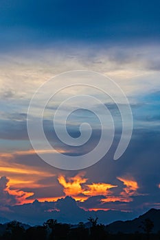 Hell in Heaven colorful Clouds Silhouette blue Sky Background Evening golden sunset with rays of light shining through clouds.