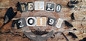 Hello 2019 lettering on brown wooden background