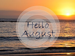 Hello August greeting on ocean sunset background.Summer concept.