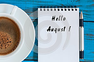 Hello August on Notebook with morning cup of coffee