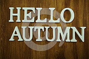 Hello autumn word made from wooden cubes with letters alphabet on wooden background