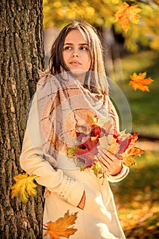 hello autumn, young woman in autumn park with falling maple leaves