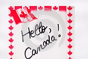 Hello Canada  handwriting on paper with Canada flag. Writing text on memo post reminder. Bucharest, Romania, 2020