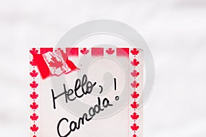 Hello Canada  handwriting on paper with Canada flag. Writing text on memo post reminder. Bucharest, Romania, 2020