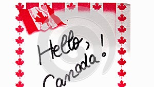 Hello Canada  handwriting on paper with Canada flag. Writing text on memo post reminder. Bucharest, Romania, 2020