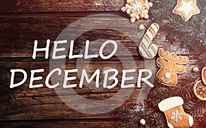 Hello December greeting card. Flat lay composition with tasty Christmas cookies on wooden table