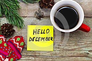 Hello December- handwriting in black ink on a sticky note with