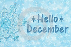 Hello December message with a blue snowflake and snowflakes