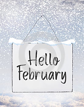 Hello February text on white plate board banner with cold snow f photo