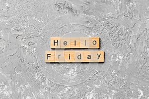 Hello friday word written on wood block. hello friday text on cement table for your desing, concept