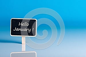 Hello january on sign at blue background with empty space for text, mockup. January 1st, the beginning of the New Year