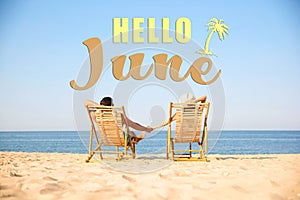 Hello June. Couple resting near sea on sunny day