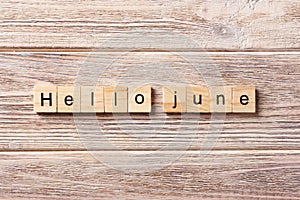 Hello June word written on wood block. Hello June text on table, concept photo