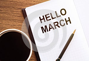 Hello March - handwriting on a napkin with a cup of coffee