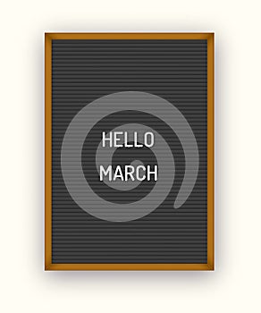 Hello March motivation quote on black letterboard black white plastic letters