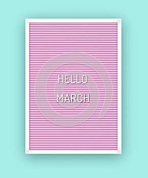 Hello March motivation quote on pink letterboard with white plastic letters