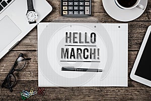 Hello March statement on notepad on office desk from above