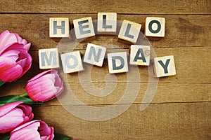 Hello Monday alphabet letters on wooden background