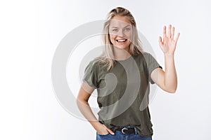 Hello nice to meet you. Portrait of friendly-looking charming outgoing female coworker with blond hair raise palm and photo