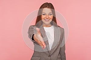 Hello, nice to meet you! Portrait of woman in business suit giving hand to handshake and smiling friendly