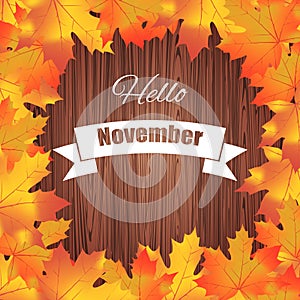 Hello november. Bright colourful autumn leaves on wood background