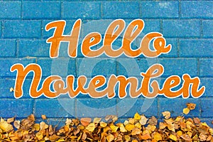 Hello november lettering. Autumn concept. Yellow leaves on blue paving stone