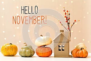 Hello November message with pumpkins with a house photo
