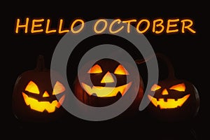 Hello October card. Halloween pumpkin heads glowing