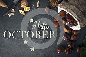 Hello october card. Roasted chestnuts on a rock table