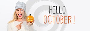 Hello October with woman holding a pumpkin photo