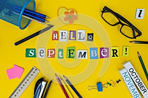 Hello september text on light yellow background with school suplies. Back to school time concept