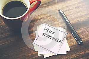 Hello September wrote at paper  with coffee cup